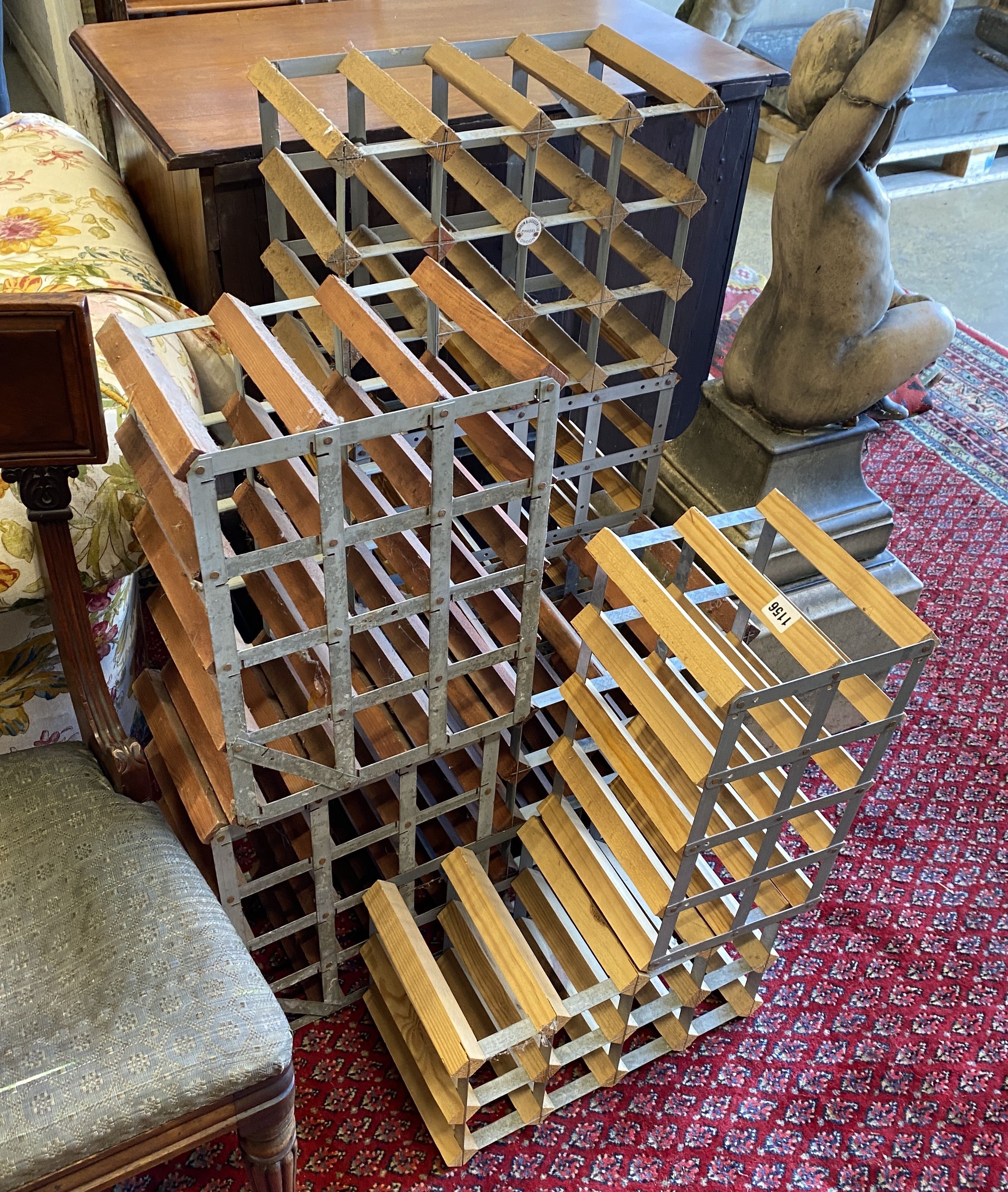 A collection of seven modern modular wine racks, largest 24 bottle capacity